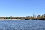 The 304 and its train sits on the bridge over the lake next to the Mannington Mills factory building 